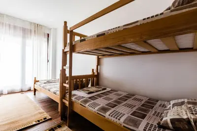a bedroom with two bunk beds and a window at Villa Ladera Lapcici in Budva