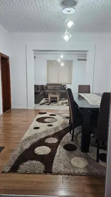 a living room with a table and a rug at Guest house Boljević in Rap
