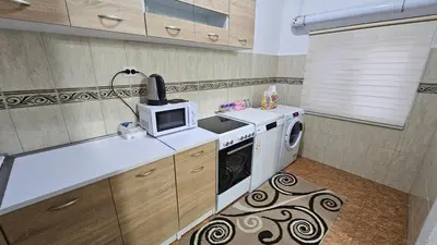 a kitchen with a stove and a microwave at Guest house Boljević in Rap