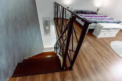 a bedroom with a bunk bed and a staircase at Aria in Cetinje