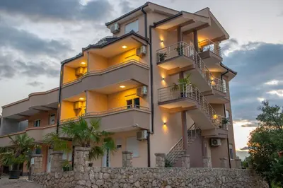 a tall building with stairs in front of it at M&M Apartments in Utjeha