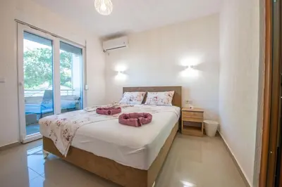 a bedroom with a bed with two towels on it at M&M Apartments in Utjeha