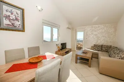 a living room with a table and a couch at Villa Lux Rajović in Budva
