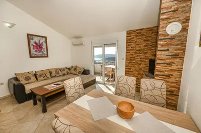 a living room with a couch and a table at Villa Lux Rajović in Budva