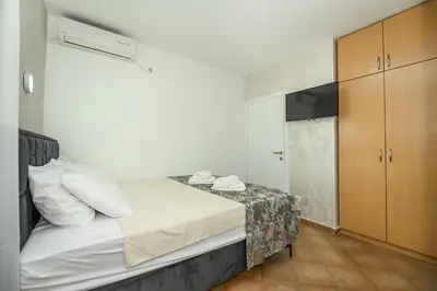 a small bedroom with a bed and a closet at Villa Lux Rajović in Budva
