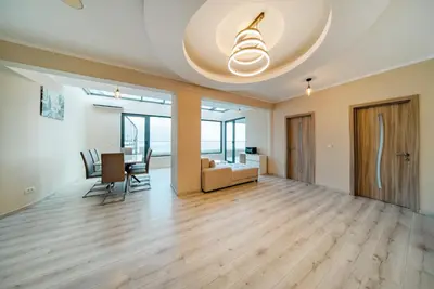 an empty living room with a table and chairs at Budva Gate Penthouse in Budva