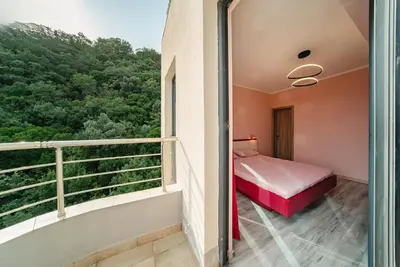 a bedroom with a bed and a balcony at Budva Gate Penthouse in Budva