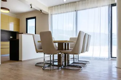 a dining room with a table and chairs at Budva Gate Penthouse in Budva