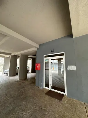 an empty parking garage with a door and a parking lot at Kropa apartman in Podgorica