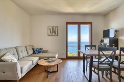 a living room with a couch and a table at Vila Aria vista in Petrovac na Moru
