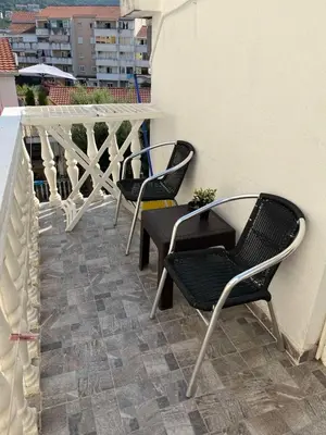 two chairs and a table on a balcony at Apartment Quince in Budva