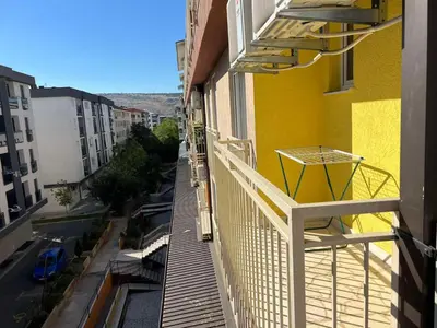 a balcony of a building with a yellow building at Golden parrot in Podgorica