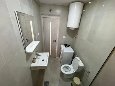 a small bathroom with a toilet and a sink at Golden parrot in Podgorica
