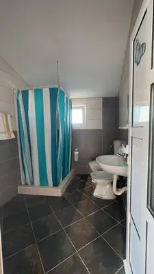 a bathroom with a shower and a toilet and a sink at Sea in Ulcinj