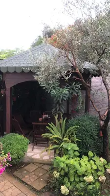 a pavilion with a bench in a garden at Sea in Ulcinj