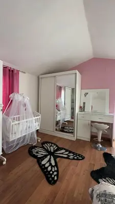 a room with a bedroom with a butterfly on the floor at Sea in Ulcinj