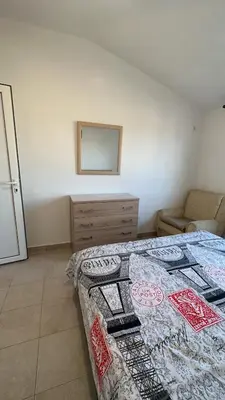a bedroom with a bed and a dresser and a mirror at Sea in Ulcinj