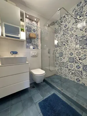 a bathroom with a shower and a toilet and a sink at City Oasis - two bedroom apartment in Blok 5 in Podgorica