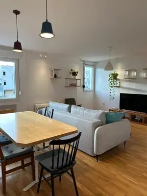 a living room with a couch and a table at City Oasis - two bedroom apartment in Blok 5 in Podgorica