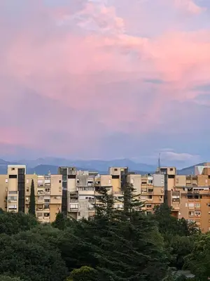 a group of apartment buildings under a cloudy sky at City Oasis - two bedroom apartment in Blok 5 in Podgorica