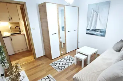 a living room with a white couch and a table at Smile in Becici