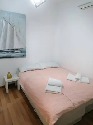 a bedroom with a bed with two towels on it at Smile in Becici