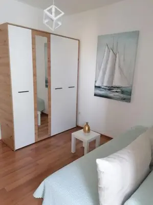 a bedroom with a bed and two large mirrors at Smile in Becici