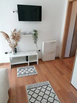 a living room with a tv on a white wall at Smile in Becici