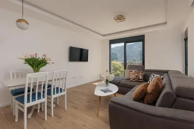 a living room with a couch and a table at Berge Apartments in Kotor