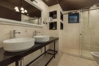 a bathroom with two sinks and a shower at Berge Apartments in Kotor