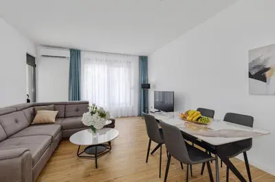 a living room with a couch and a table at Berge Apartments in Kotor