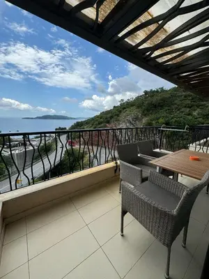 a balcony with chairs and a view of the ocean at Miločer Apartman Beograd in Pržno