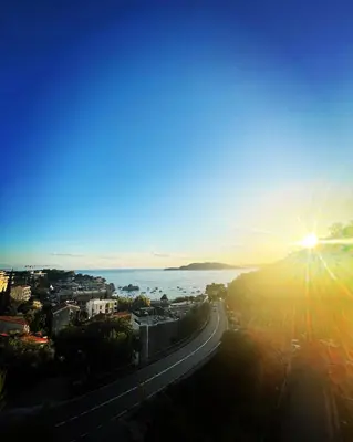 a view of the sun setting over the water at Miločer Apartman Beograd in Pržno