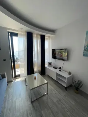 a living room with a couch and a table at Miločer Apartman Beograd in Pržno