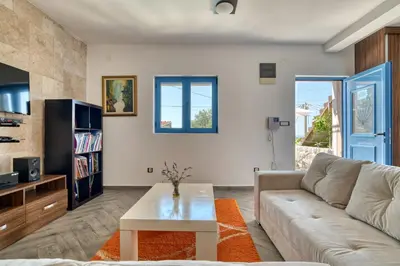 a living room with a couch and a table at Villa Old Olive in Budva