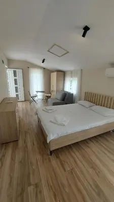 a large bedroom with a bed and a couch at Superb Apartments Virpazar in Virpazar