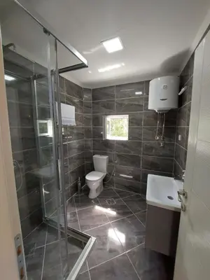 a bathroom with a shower and a toilet and a sink at Superb Apartments Virpazar in Virpazar