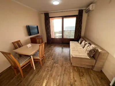 a living room with a couch and a table at Apartment Sea View Dobra Voda in Dobra Voda