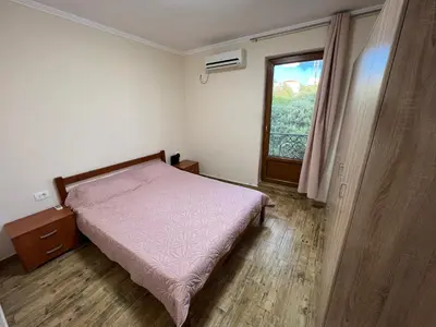 a small bedroom with a bed and a window at Apartment Sea View Dobra Voda in Dobra Voda