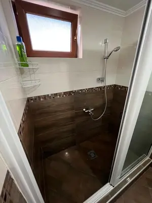 a shower with a glass door in a bathroom at Apartment Sea View Dobra Voda in Dobra Voda