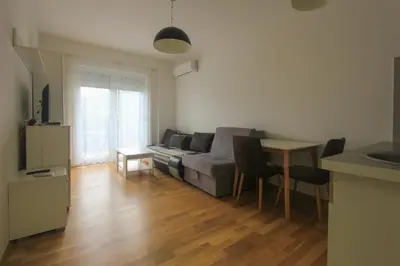 a living room with a couch and a table at Studio 13 Budva in Budva