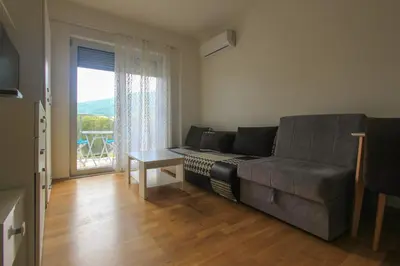 a living room with a couch and a table at Studio 13 Budva in Budva