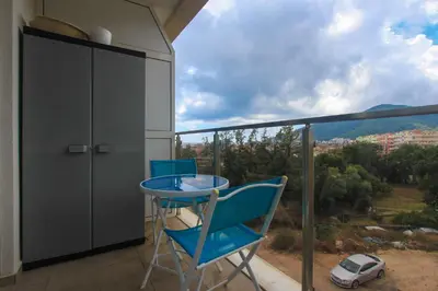 a blue table and chairs on a balcony with a view at Studio 13 Budva in Budva