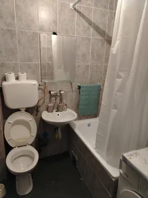 a bathroom with a toilet and a sink and a tub at Coastal View Apartment in Bar