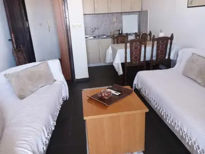 a room with two beds and a tray of food on a table at Coastal View Apartment in Bar