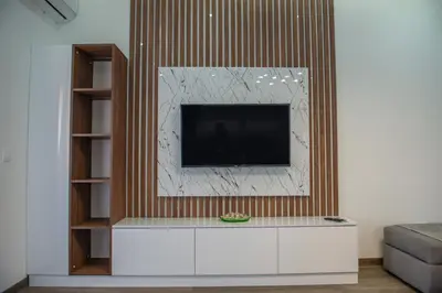a living room with a tv on a wall at Apartment Lara in Ulcinj