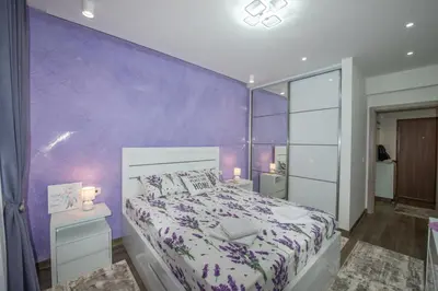 a purple bedroom with a bed and a purple wall at Apartment Lara in Ulcinj
