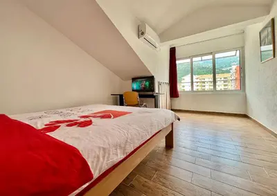a bedroom with a large bed and a large window at Homestay Mark - DOUBLE BED ROOM - shared bathroom in Budva