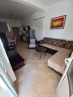 a living room with a couch and a table at Apartmani Vujovic Markovici in Budva