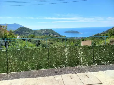 a fence with a view of the ocean at Apartmani Vujovic Markovici 2 in Budva
